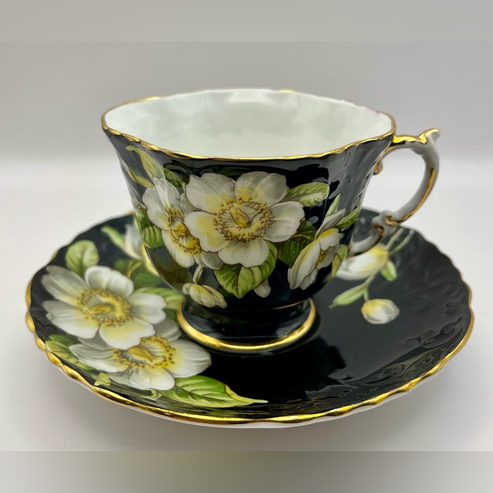 Aynsley teacup& saucer, Dogwood flowers on a Black cup and saucer with gold trim